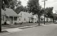 street in the late 1950s — quiet, mid-afternoon
