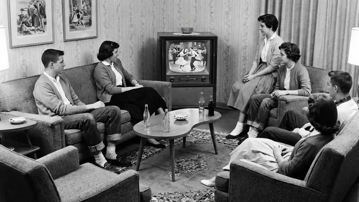 1950s teenagers watching American Bandstand on a small television in a living room